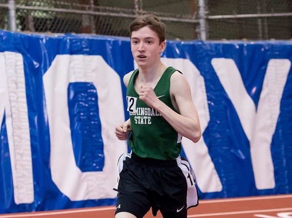 Evan McCrann running in the mile run, picture from the side